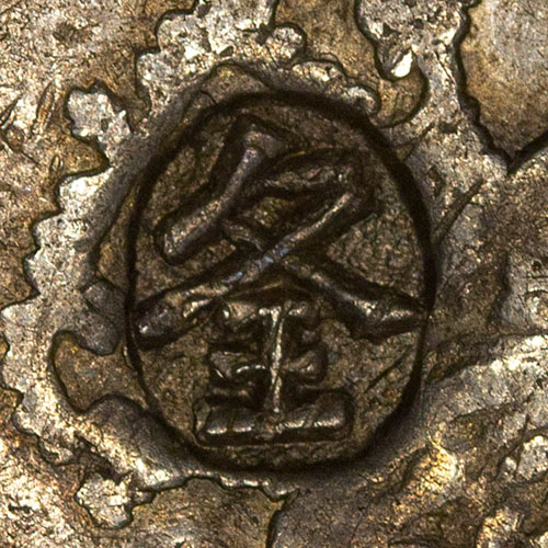 夊王 - combination of 夊 *suī*, meaning "see" and 王 *wàng* meaning "king" or "to rule over" which is interesting because it is punched over the royal crown